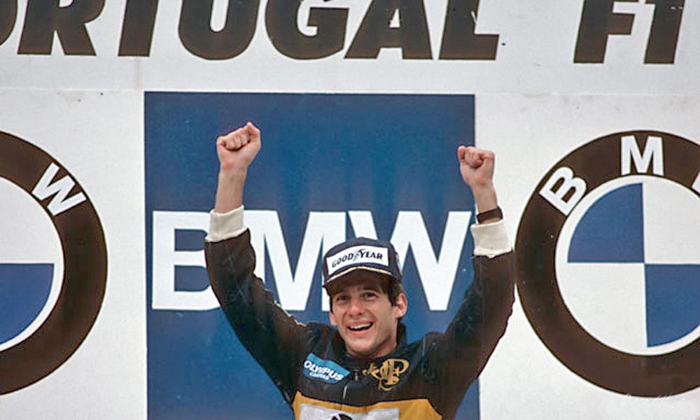 Aryton Senna celebrates victory in the 1985 Portugal Grand Prix